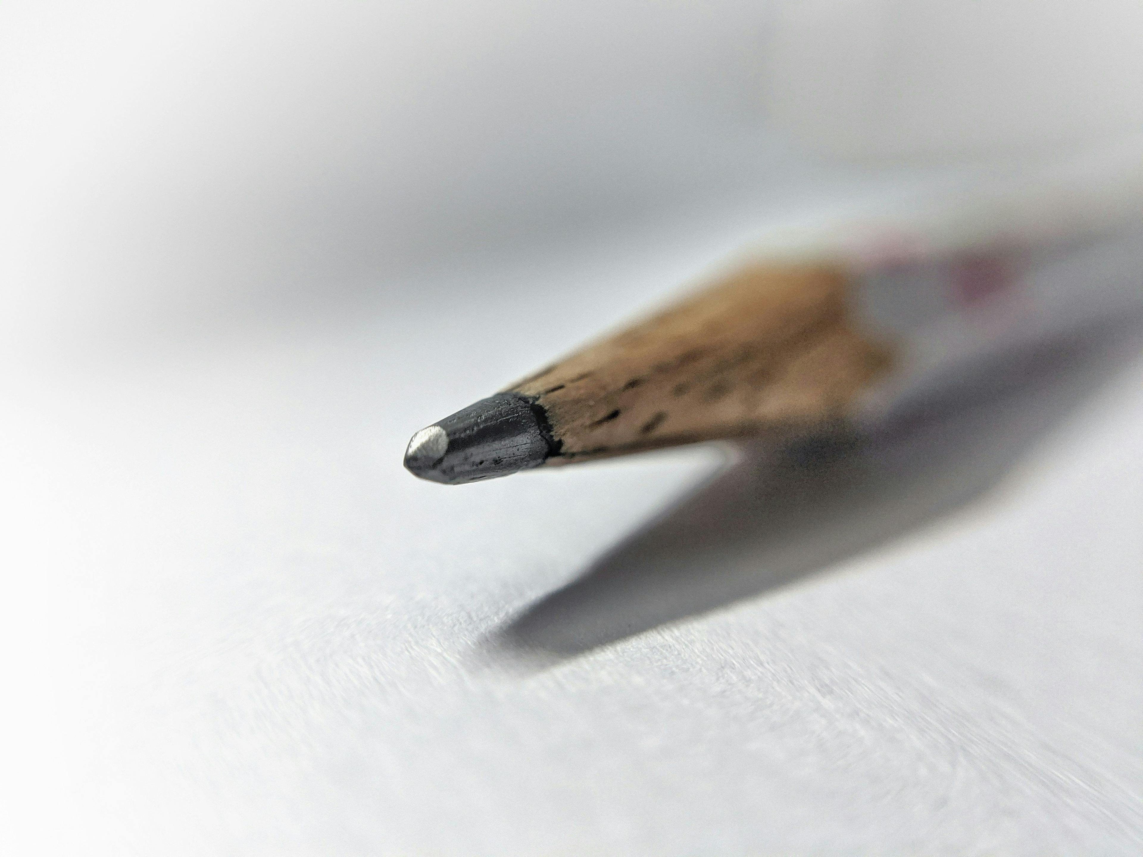 a close up of a pencil with a white background